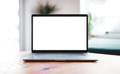 Wall Mural - laptop blank screen mockup on table in living room - front view