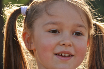 Portrait of a little cute smiling girl with 2 pony-tails..Happy, toddler girl with adorable smile.