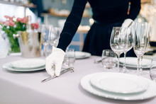 Waitress In Gloves Puts The Knife, Table Setting