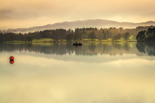 Early Morning Mist On Lake Windermere The Largest Natural Lake In England. It Is A Ribbon Lake Formed In A Glacial Trough After The Retreat Of Ice At The Start Of The Current Interglacial Period. 