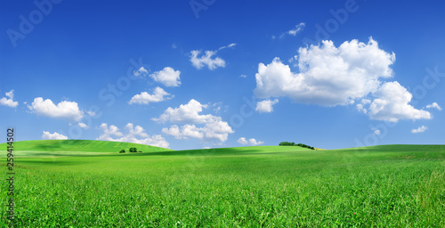 Fotografía Idyllic view, green hills and blue sky with white clouds