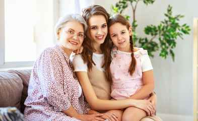 Wall Mural - family three generations  grandmother, mother and child play and laugh at home