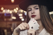 © RomanR - Young lady in casino with four aces