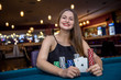 © RomanR - Woman in casino showing combination of aces