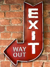 Close Up Of Vintage Red Sign Exit/Way Out, Retro Style On The Brick Wall Of The Building. 