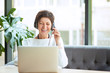 © hbrh - Happy aged woman in headset and laptop at table