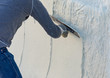 © Andy Dean - Worker Smoothing Wet Pool Plaster With Trowel
