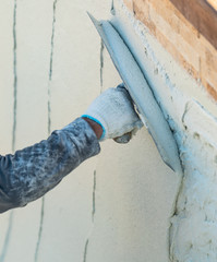 Wall Mural - Worker Smoothing Wet Pool Plaster With Trowel