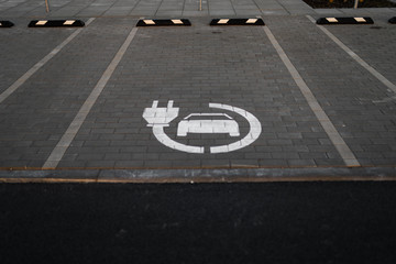 Wall Mural - Electric car free charge - Empty parking lots during Golden Hour sunset at a popular typical Shopping centre