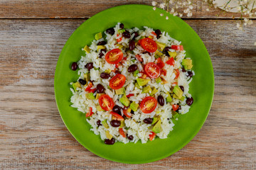 Wall Mural - Healthy green vegetarian lunch with rice, tomato, avocado on table. Trend cuisine. Top view. Flat lay