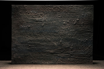 Grungy dark stucco wall with spotlight