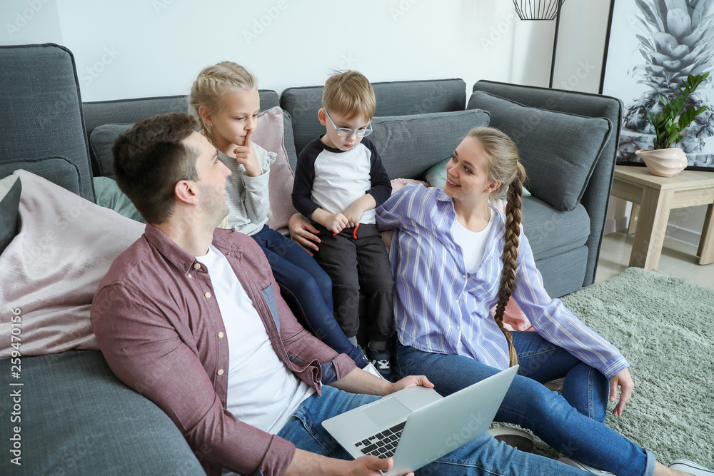 Happy family watching cartoons at home