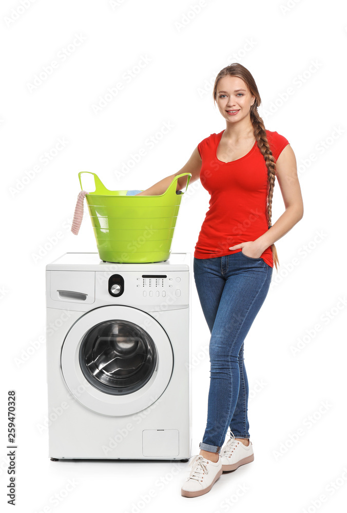 Young woman with washing machine on white background