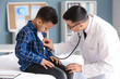 © Pixel-Shot - Pediatrician examining African-American boy in clinic