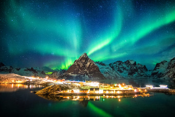 Wall Mural - aurora borealis over mountains in fishing village