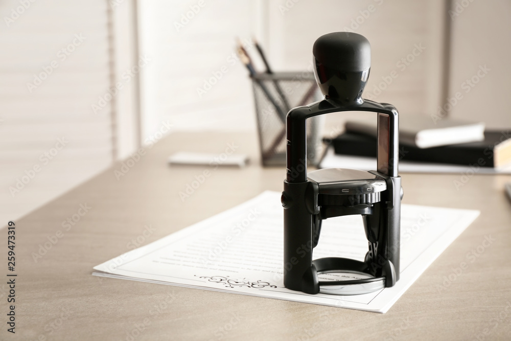 Document and stamp on table of notary public