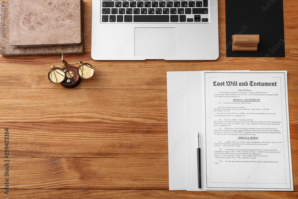 Document, stationery and laptop on table of notary public