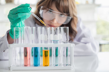 Wall Mural - a young asian woman scientist working in laboratory with test tube microscope and solutions.