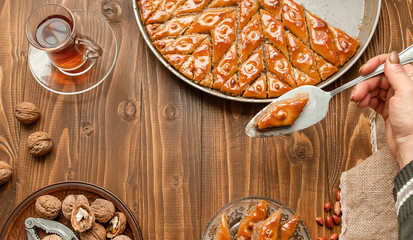 Baklava with nuts on a wooden background. Selective focus.