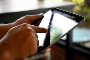 Wall Mural - businessman hand working on tablet on wooden desk tablet with blank screen mockup Digital tablet computer