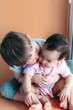 © Anastassiya  - happy little brother playing hugs his sister baby, boy and girl embraces kisses, concept love and parenting