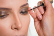 © Impact Photography - Make up artist applying eyeliner on female client's eyelids