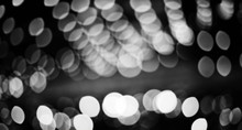 Magic Shiny Bokeh Lights, Fantastic Abstract Background. Beautiful Black White Monochrome Glowing Pattern