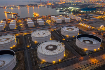 Aerial view. Oil refinery factory and oil storage tank at twilight and night. Petrochemical Industrial.