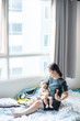 © themorningglory - Office women playing with infant baby boy in cozy room