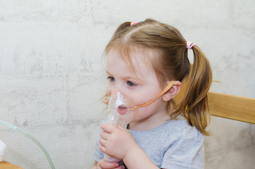 little girl makes inhalation