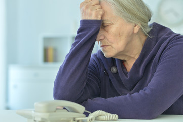 Wall Mural - upset senior woman with phone