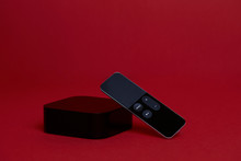 Black Digital Media Player with Remote on a Red Background