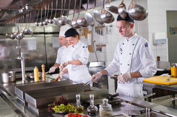 Wall Mural - work of a group of chefs in a luxury restaurant.