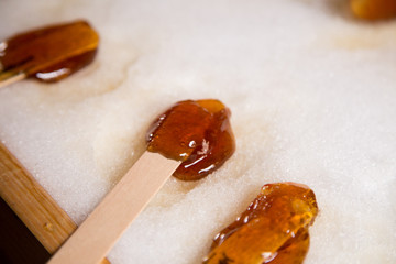 Wall Mural - Making maple candy on snow in a maple sugar camp in New Brunswick