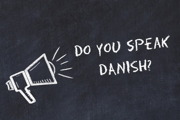 Learning foreign languages concept. Chalk symbol of loudspeaker with phrase do you speak danish