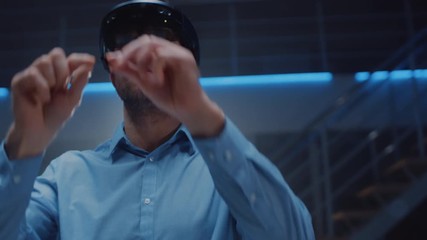 Poster - In 3D Content Creating Laboratory Engineer Wearing Professional Virtual Reality Headset Works and Gestures in Augmented Reality. Stylish Low Angle Arc Portrait Shot 