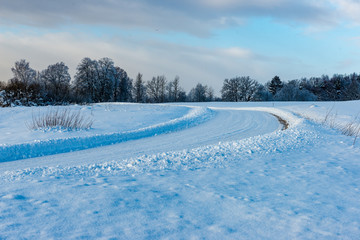 snowy winter road covered in ice and snow