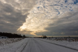 Fototapeta Na sufit - snowy winter road covered in ice and snow
