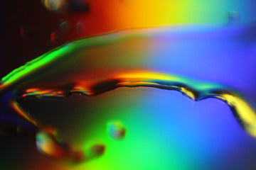 Fototapete - abstract liquid colorful background with water droplets and splash on holographic surface