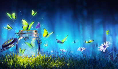 Wall Mural - freedom concept - magic butterflies flying out of the jar on the lawn