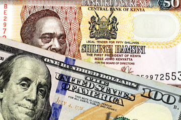 Wall Mural - A close up image of a blue American one hundred dollar bill close up with a fifty Kenyan shilling bank note in macro