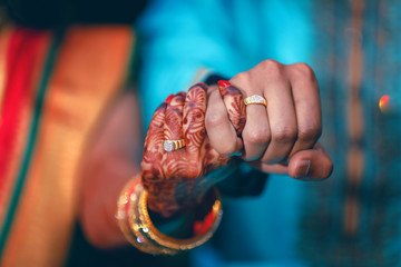 Golden engagement ring in hand