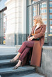 © Galina Zhigalova - Stylish fashionable blonde woman wearing coat and sunglasses, street style photo