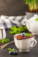 Wall Mural - Mug Cake with chocolate and blueberries