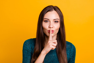 Sticker - Close up photo beautiful her she lady arm hand finger touch lips not tell speak talk chatterbox rumours kindhearted wear jeans denim green knitted pullover jumper isolated yellow background