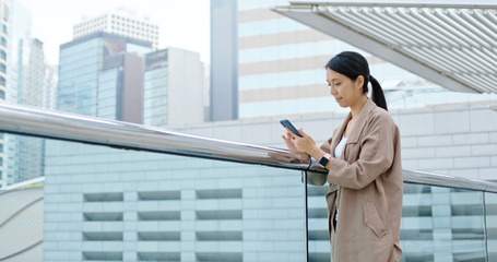 Wall Mural - Woman read on mobile phone at outdoor