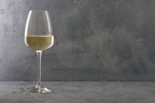 Glass Of White Wine On Vintage Wooden Table