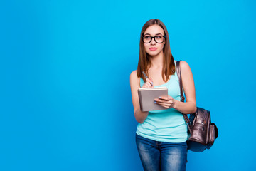 Close up photo beautiful she her lady hold study applies back bag listen teacher attentively write notes pencil intelligent wear specs casual jeans denim tank top clothes isolated blue background