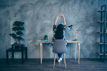 Wall Mural - Rear back behind view of her she nice executive manager brunette lady wearing checked shirt stretching tired at industrial loft style interior room work place station