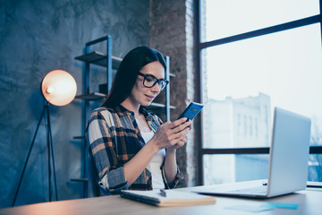 Wall Mural - Portrait of nice cute attractive charming brunette lady in checked shirt chatting client it support at industrial loft style interior work place station open space indoors